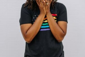 A black woman covering her mouth