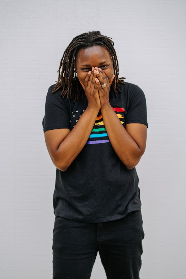 A black woman covering her mouth