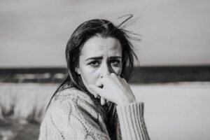 A grayscale of a woman looking sad and worried