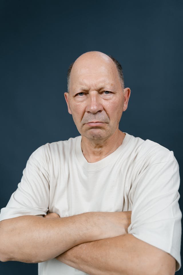 Picture of an angry man crossing his arms 