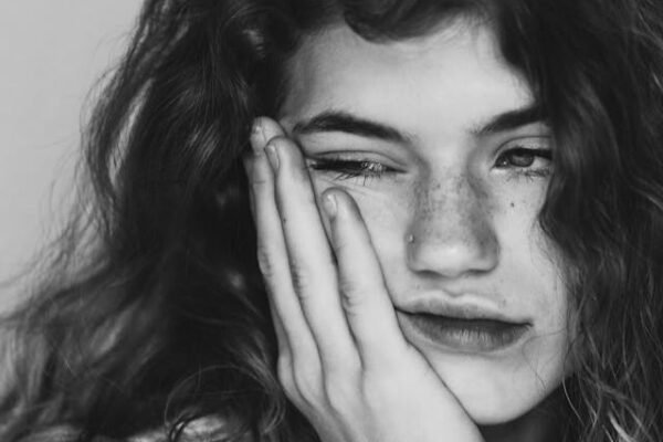 A woman looking deflated and propping sorrows