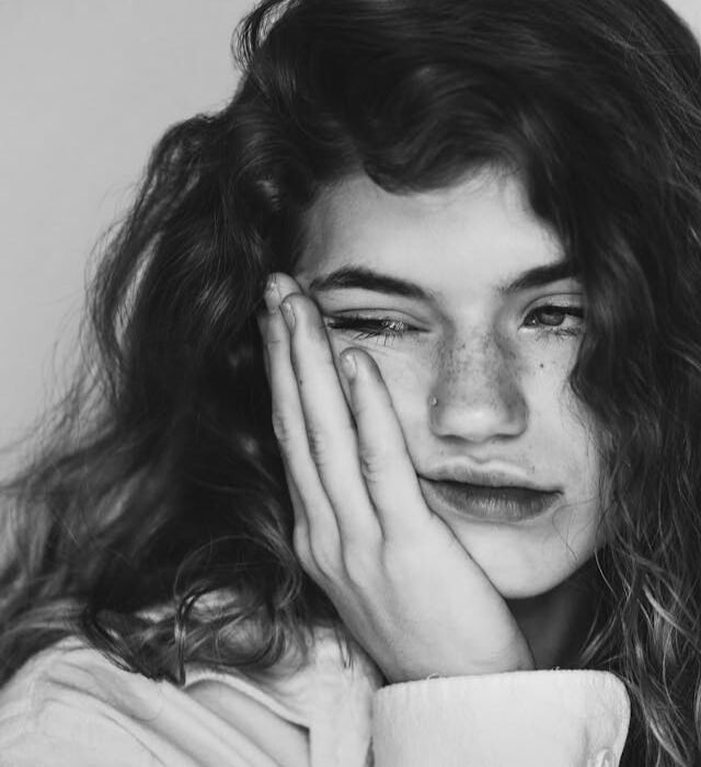 A woman looking deflated and propping sorrows