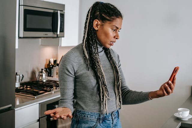 An image of a confused woman on a video call looking irritated
