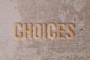 A plain beige canvas with the word Choices written in a darker beige colour