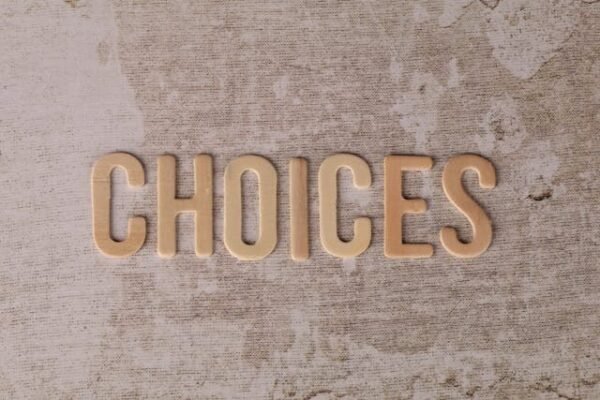 A plain beige canvas with the word Choices written in a darker beige colour