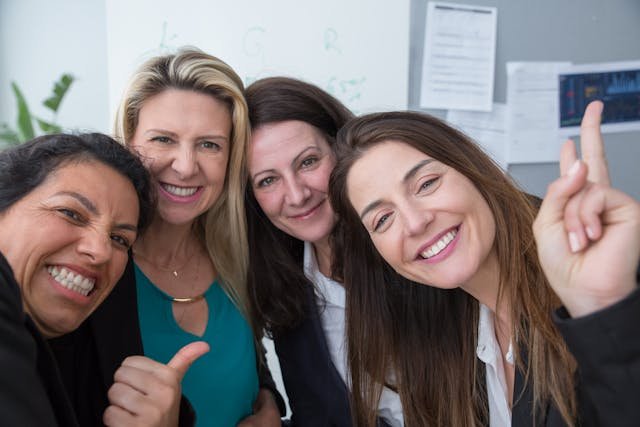 A group of middle aged women posing for a photo