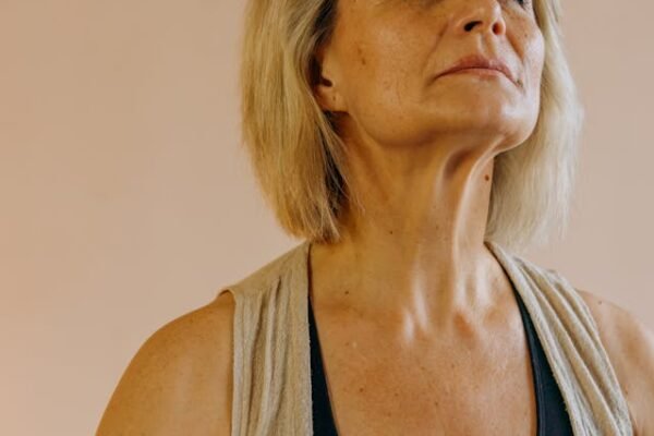 A middle aged woman looking up and looking like she is trying to hold her world inside her
