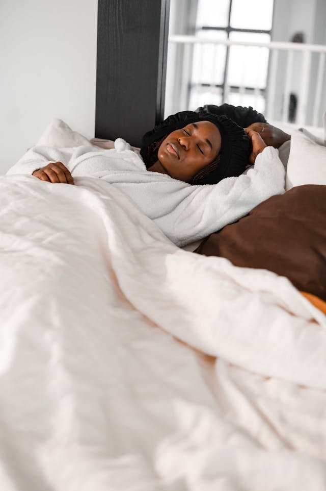 A woman lying on her bed content and relaxing