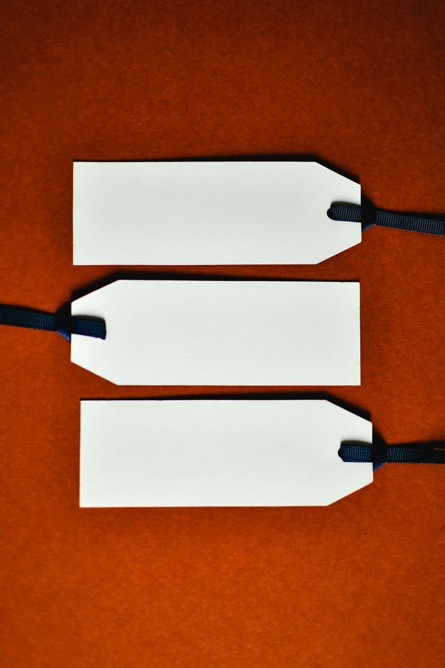 Image of 3 white plain label tags on a red background