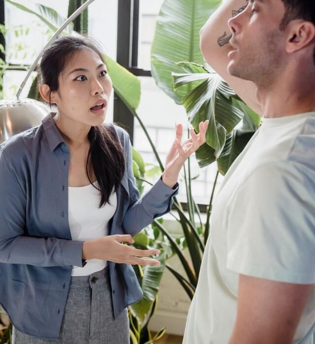 A man and a woman with the woman disagreeing with the man and the man holding his head in dispair.