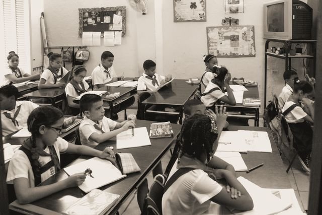 A Black & White image of a classroom full of kids back in the day